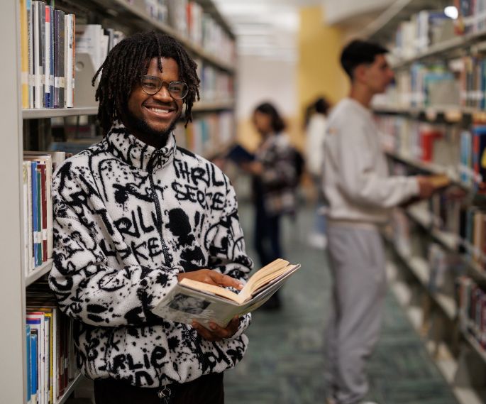 GCC student holding a book