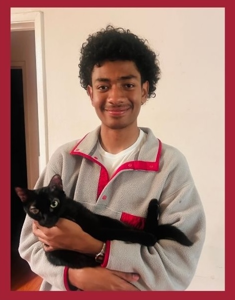 Photo of tutor Andre. He is holding a cat.